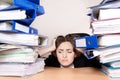 Frustrated businesswoman with stack of folders