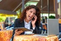 Frustrated businesswoman yelling into her mobile