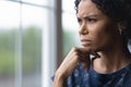 Frustrated concerned millennial African American woman looking out of window Royalty Free Stock Photo