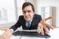 Frustrated confused and unsure man is working with computer in office