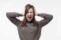 Frustrated, confused woman holding her head in her hands. Royalty Free Stock Photo