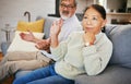 Frustrated couple, argument and fight on sofa in conflict, divorce or disagreement in living room at home. Unhappy man