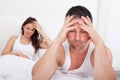 Frustrated couple on bed Royalty Free Stock Photo