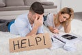 Frustrated Couple Holding Help Sign