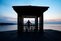 Frustrated depressed man wearing hoodie standing alone on wooden