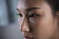 Frustrated and depressed young Asian woman is crying tears coming from her eyes Royalty Free Stock Photo