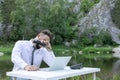 Frustrated, displeased young bearded man, guy. Trying to focus on work. tired of office work