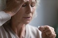 Frustrated elderly 60s lady holding dose of pills Royalty Free Stock Photo