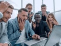 Frustrated females and males sales managers working in showroom, looking at laptop monitor Royalty Free Stock Photo