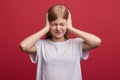 Frustrated girl with closed eyes tries not to listen to her parents` scandal Royalty Free Stock Photo