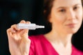 Frustrated girl nurse closeup holds a test for coronavirus. focus on the result