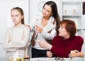 Frustrated girl while mother and grandmother berating her Royalty Free Stock Photo