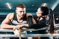 Frustrated guy in boxing ring. beautiful girl supports young man.