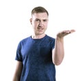 A frustrated guy puts out his hand in doubt. A stressed student isolated on a white background. Ignorance and disregard concept.