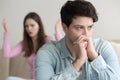 Frustrated husband tired of quarrelling, thoughtful and ignoring