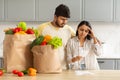 Frustrated indian couple checking bills after grocery shopping Royalty Free Stock Photo