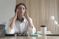 Frustrated Italian woman with closed eyes massaging temples, suffering from headache at work Royalty Free Stock Photo