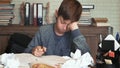 Frustrated little boy tired of his homework crumples his paper