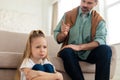 Frustrated Little Girl Sulking While Dad Scolding Her At Home