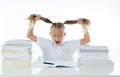 Frustrated little schoolgirl feeling a failure unable to concentrate in reading and writing difficulties learning problem Royalty Free Stock Photo