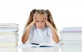 Frustrated little schoolgirl feeling a failure unable to concentrate in reading and writing difficulties learning problem Royalty Free Stock Photo