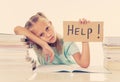 Frustrated little schoolgirl feeling a failure unable to concentrate in reading and writing difficulties learning problem