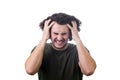 Frustrated, mad young man messing up and pulling his hair, hands to head, eyes closed screaming and clenching teeth isolated on Royalty Free Stock Photo