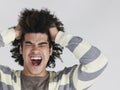 Frustrated Man With Afro Hairdo Pulling Hair