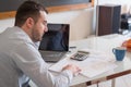 Frustrated man calculating bills and tax outcomes Royalty Free Stock Photo