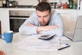 Frustrated man calculating bills and taxes Royalty Free Stock Photo