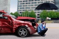 Frustrated man with damaged car and umbrella Royalty Free Stock Photo