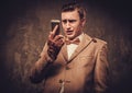 Frustrated man with mobile phone wearing jacket and bow tie Royalty Free Stock Photo