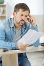 Frustrated man reading instruction to self assembly furniture Royalty Free Stock Photo