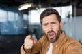 Frustrated man shouting and pointing finger expressing aggression Royalty Free Stock Photo