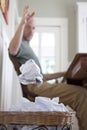 A frustrated man throwing away another paper Royalty Free Stock Photo