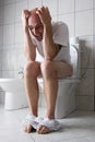 Frustrated man on toilet seat