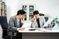 Frustrated manager scolds employee in office over financial error. Concept of workplace stress, reporting issues, conflict Royalty Free Stock Photo