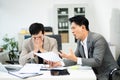 Frustrated manager scolds employee in office over financial error. Concept of workplace stress, reporting issues, conflict Royalty Free Stock Photo