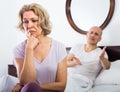 Mature couple having quarrel in bedroom. Royalty Free Stock Photo