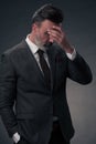 Frustrated middle aged elegant man Close up face of stressed businessman wearing stylish suit with eyes closed Royalty Free Stock Photo