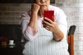 Frustrated older mature woman feeling boring desperate looking on the smartphone, stressed sad middle aged female depressed Royalty Free Stock Photo