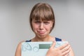 Frustrated overweight woman with scales