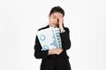 Frustrated overworked and confused young Asian business woman in suit troubled with financial problem over white isolated Royalty Free Stock Photo