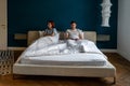 Disappointed woman consider break up divorce sad sit with crossed arms on bed ignore husband at home Royalty Free Stock Photo
