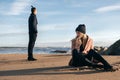 Frustrated sad girlfriend sit on sand think of relationship problems.