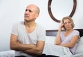 Mature couple having quarrel in bedroom. Royalty Free Stock Photo