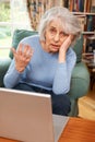 Frustrated Senior Woman Trying To Use Laptop Computer Royalty Free Stock Photo