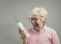 Frustrated senior woman using an old telephone