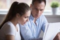 Frustrated spouses checking domestic bills at home Royalty Free Stock Photo