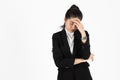 Frustrated stressed Asian business woman with hands on face suffering from severe depression on white isolated background. Royalty Free Stock Photo